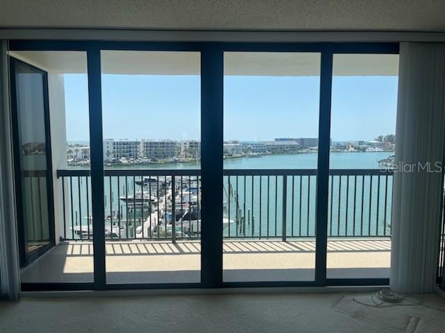 doorway to outside featuring plenty of natural light and a water view