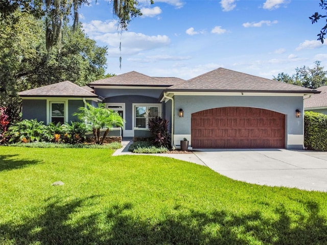 ranch-style house featuring concrete driveway, a front lawn, a garage, and stucco siding