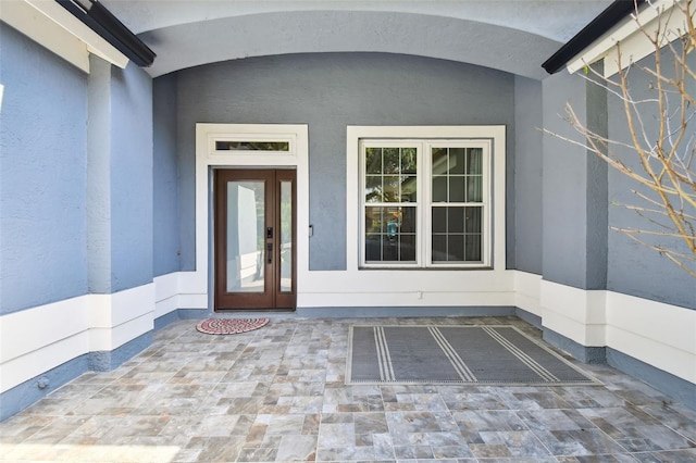 entrance to property with stucco siding