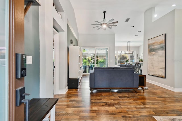 foyer entrance featuring visible vents, baseboards, a ceiling fan, and wood finished floors
