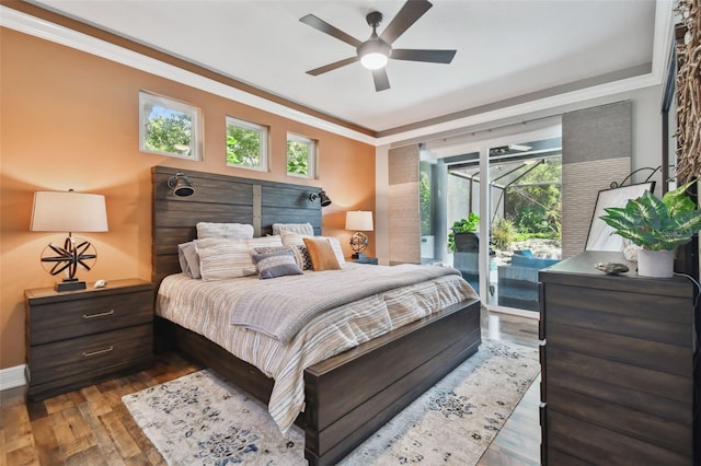 bedroom featuring baseboards, ornamental molding, a ceiling fan, access to exterior, and hardwood / wood-style floors