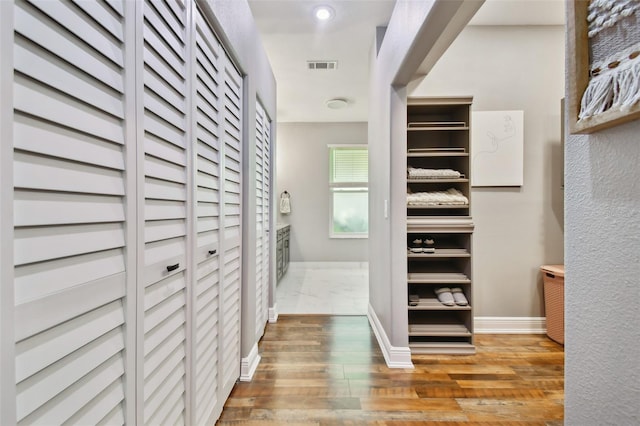 spacious closet with wood finished floors and visible vents