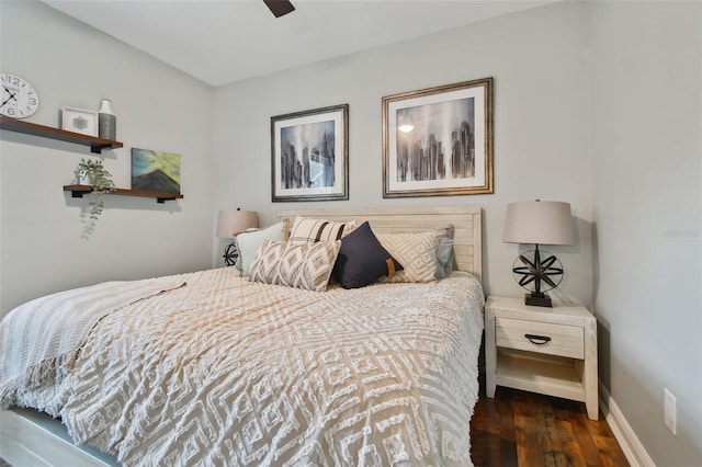 bedroom featuring wood finished floors, baseboards, and a ceiling fan