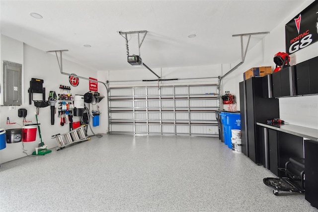 garage featuring a garage door opener and electric panel