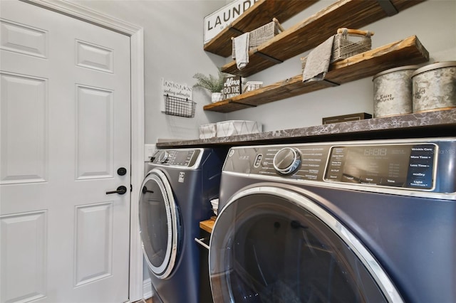 laundry room featuring separate washer and dryer and laundry area
