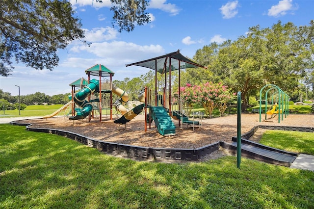 communal playground featuring a lawn