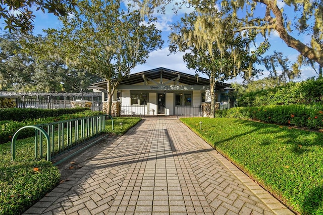 view of property's community with a yard and a fenced front yard