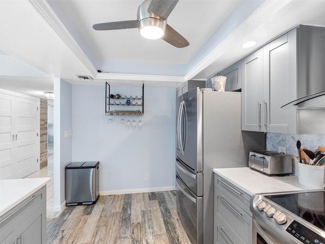 1430 Gulf Blvd Unit 102, Clearwater Beach, FL 33767 - kitchen with light wood finished floors, ceiling fan, gray cabinetry, and light countertops