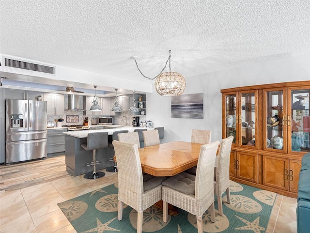 1430 Gulf Blvd Unit 102, Clearwater Beach, FL 33767 - dining space with visible vents, a chandelier, light tile patterned floors, and a textured ceiling