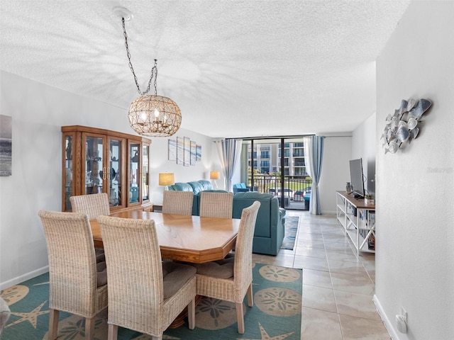 1430 Gulf Blvd Unit 102, Clearwater Beach, FL 33767 - dining room featuring baseboards, a notable chandelier, and a textured ceiling
