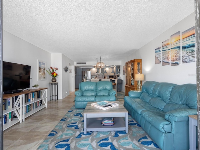 1430 Gulf Blvd Unit 102, Clearwater Beach, FL 33767 - living room featuring an inviting chandelier and a textured ceiling