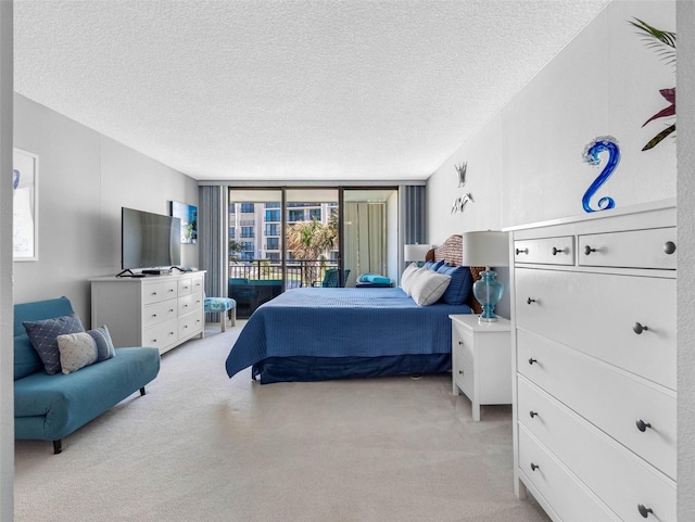 1430 Gulf Blvd Unit 102, Clearwater Beach, FL 33767 - bedroom featuring access to outside, light carpet, and a textured ceiling