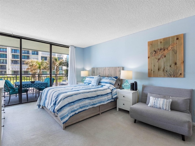 1430 Gulf Blvd Unit 102, Clearwater Beach, FL 33767 - bedroom with carpet floors, a wall of windows, access to outside, and a textured ceiling