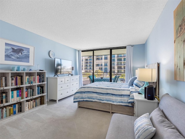 1430 Gulf Blvd Unit 102, Clearwater Beach, FL 33767 - bedroom with access to outside, carpet, and a textured ceiling
