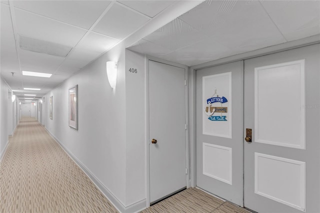 1460 Gulf Blvd Unit 406, Clearwater Beach, FL 33767 - corridor with a paneled ceiling, carpet flooring, and baseboards