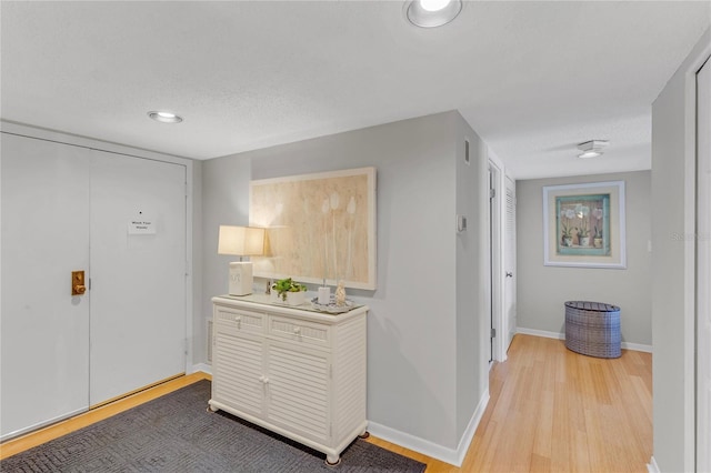 1460 Gulf Blvd Unit 406, Clearwater Beach, FL 33767 - hallway featuring light wood-style floors, baseboards, and recessed lighting