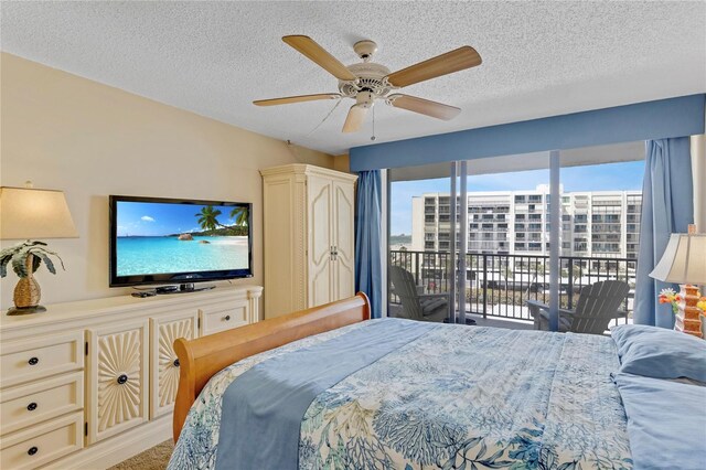 1460 Gulf Blvd Unit 406, Clearwater Beach, FL 33767 - bedroom with multiple windows, ceiling fan, access to outside, and a textured ceiling