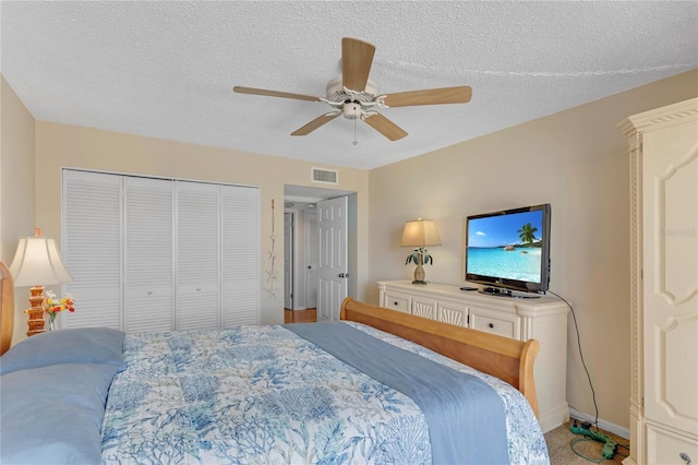 1460 Gulf Blvd Unit 406, Clearwater Beach, FL 33767 - carpeted bedroom featuring visible vents, a closet, a textured ceiling, and ceiling fan