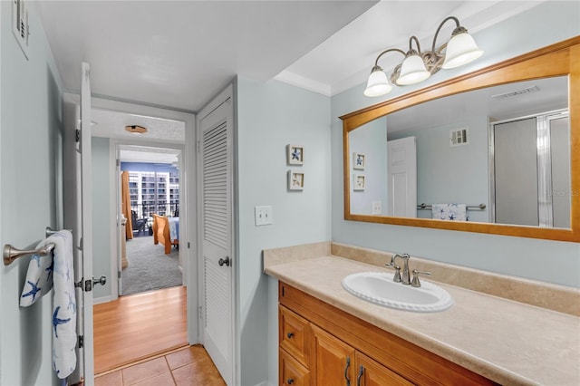1460 Gulf Blvd Unit 406, Clearwater Beach, FL 33767 - bathroom with tile patterned floors, a shower with shower door, vanity, and visible vents