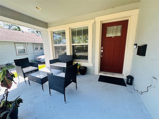 exterior space featuring a patio, an outdoor hangout area, and stucco siding