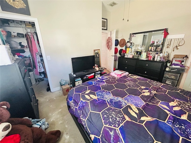 bedroom featuring visible vents and a high ceiling