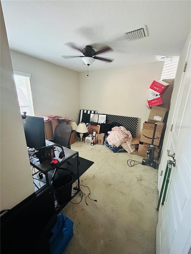bedroom featuring visible vents, ceiling fan, and carpet