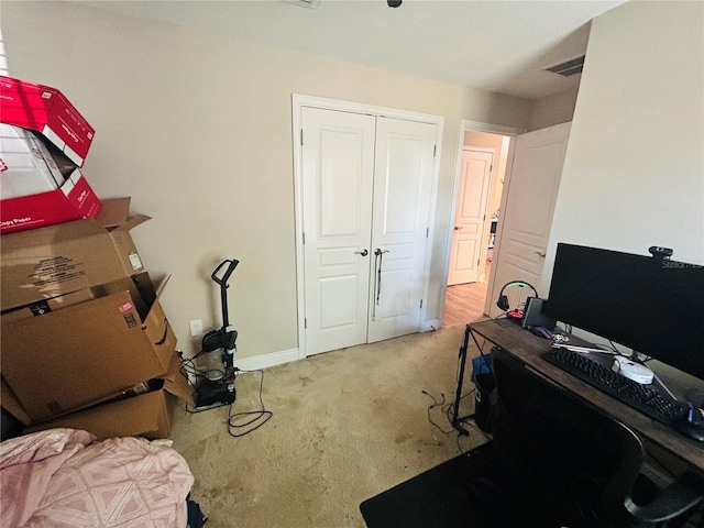 office featuring carpet, visible vents, and baseboards