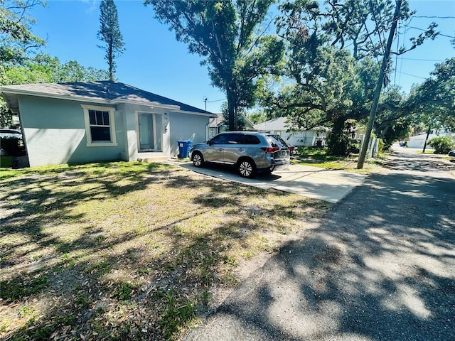 exterior space with driveway and stucco siding