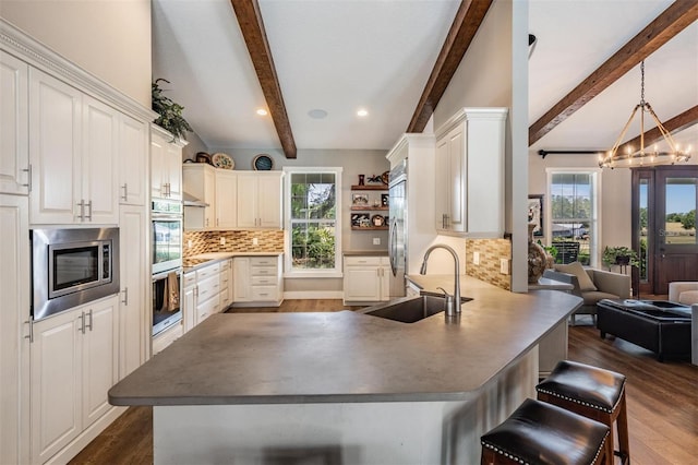 25601 Hutcheson Ln, Sorrento, FL 32776 - kitchen with dark wood-style floors, a sink, a peninsula, and a healthy amount of sunlight