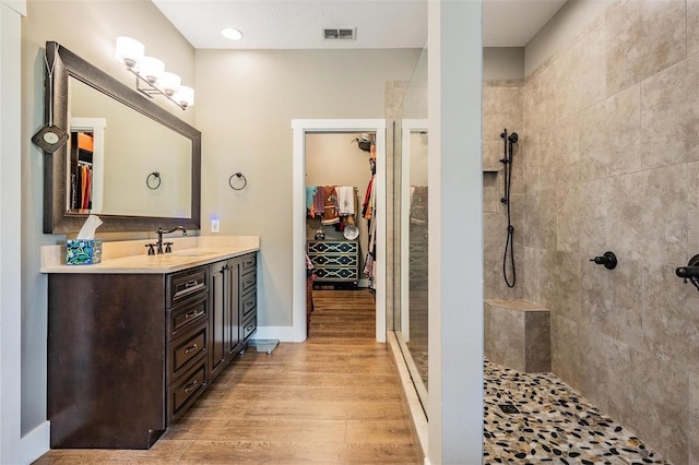 25601 Hutcheson Ln, Sorrento, FL 32776 - bathroom featuring a spacious closet, visible vents, walk in shower, wood finished floors, and vanity