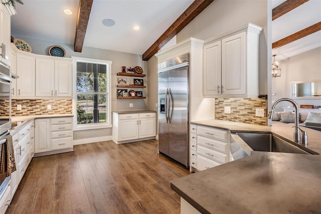 25601 Hutcheson Ln, Sorrento, FL 32776 - kitchen featuring built in refrigerator, backsplash, a sink, and white cabinetry