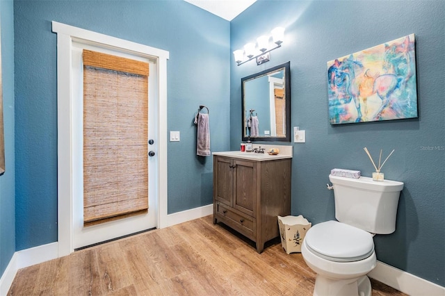 25601 Hutcheson Ln, Sorrento, FL 32776 - bathroom with baseboards, wood finished floors, toilet, and vanity