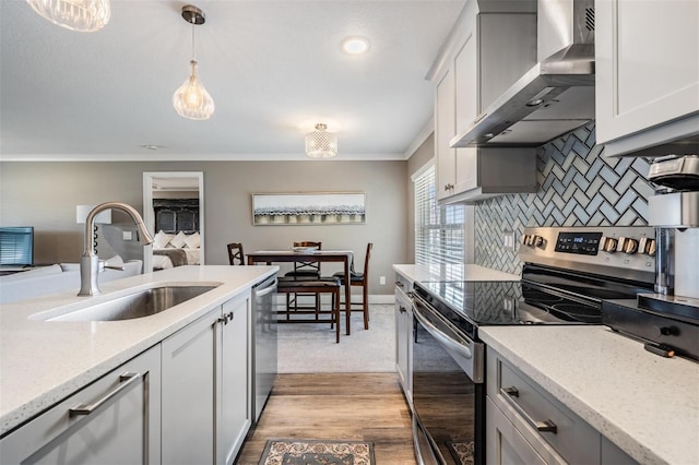 25601 Hutcheson Ln, Sorrento, FL 32776 - kitchen featuring decorative backsplash, crown molding, a sink, appliances with stainless steel finishes, and wall chimney exhaust hood