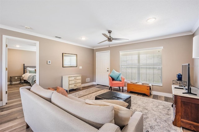 25601 Hutcheson Ln, Sorrento, FL 32776 - living area featuring ornamental molding, visible vents, ceiling fan, and light wood-style floors