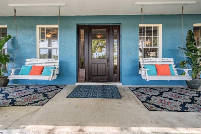 25601 Hutcheson Ln, Sorrento, FL 32776 - entrance to property with stucco siding and covered porch