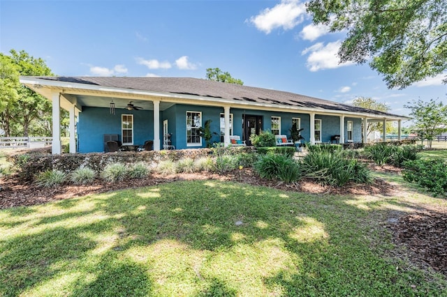 25601 Hutcheson Ln, Sorrento, FL 32776 - view of front of house with fence, a ceiling fan, a front yard, and stucco siding