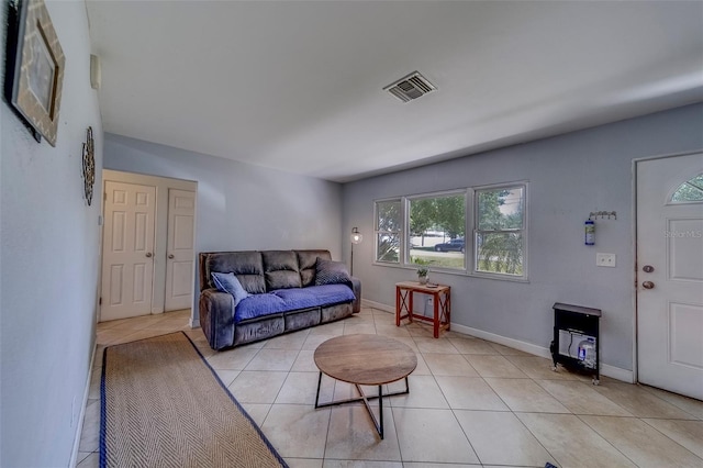 living area featuring visible vents, baseboards, and light tile patterned floors
