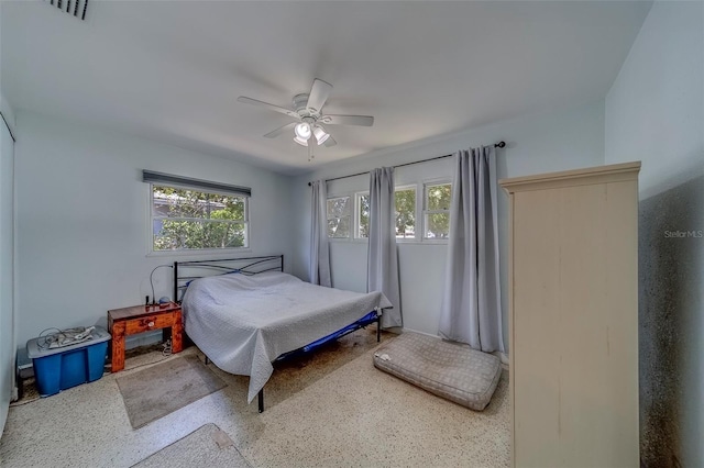 bedroom with visible vents, speckled floor, and ceiling fan
