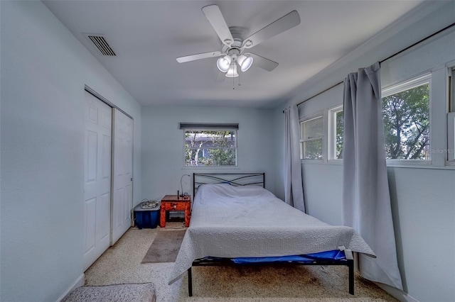bedroom with visible vents, ceiling fan, and a closet