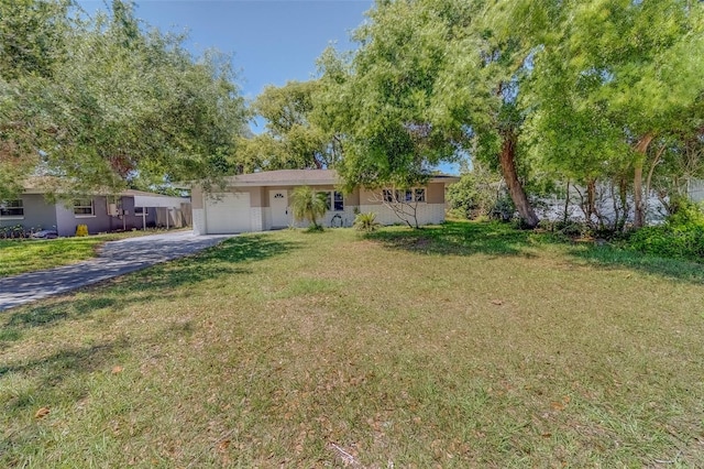 ranch-style house featuring an attached garage, stucco siding, driveway, and a front lawn
