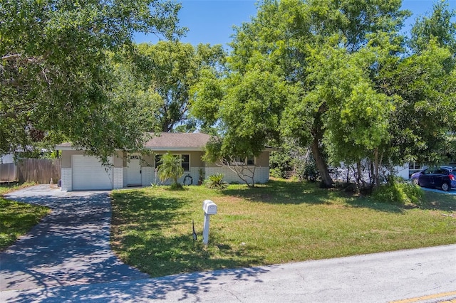 ranch-style house with driveway, a front yard, brick siding, a garage, and fence
