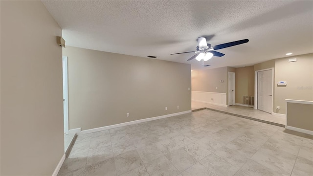 spare room with visible vents, a textured ceiling, and ceiling fan