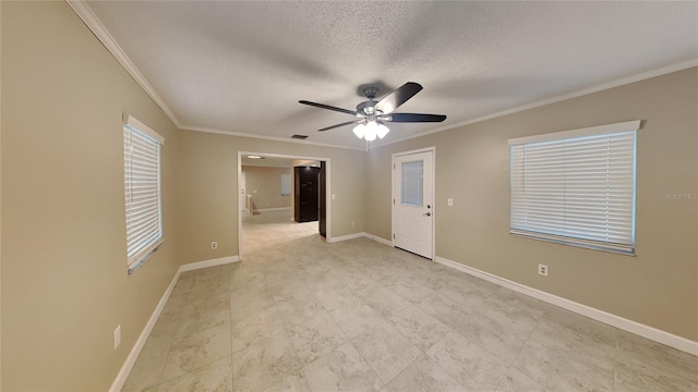empty room with crown molding, ceiling fan, a textured ceiling, visible vents, and baseboards