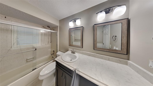 full bath with toilet, vanity, shower / bath combination with glass door, and a textured ceiling