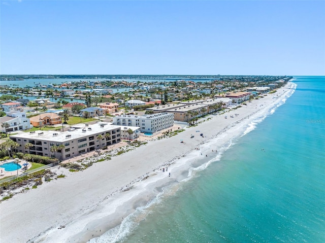 birds eye view of property with a water view and a view of the beach