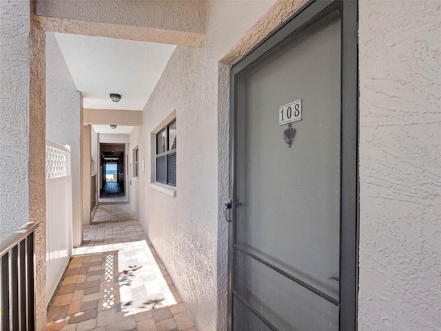 property entrance with stucco siding
