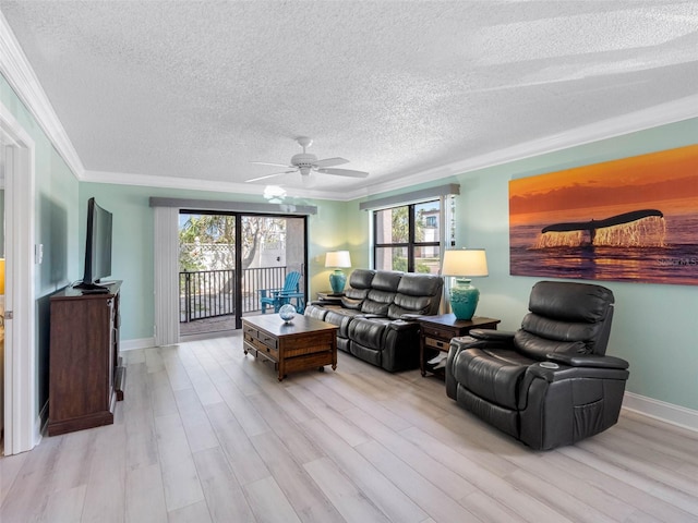 living room featuring crown molding, light wood-type flooring, and a textured ceiling