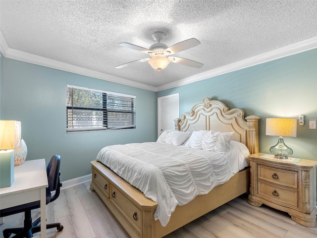 bedroom with ornamental molding, light wood finished floors, and a textured ceiling