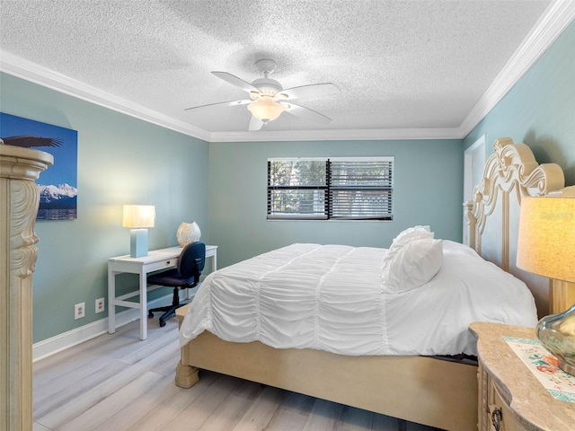 bedroom featuring a ceiling fan, ornamental molding, light wood-type flooring, and a textured ceiling