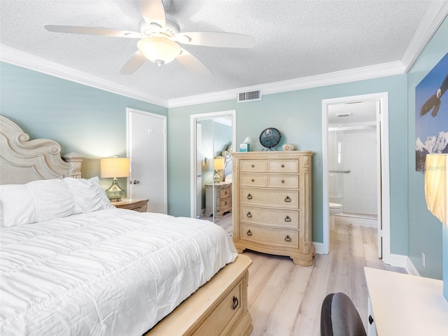 bedroom with light wood-type flooring, a textured ceiling, ensuite bath, ornamental molding, and visible vents